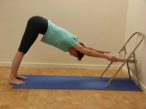 Downward facing dog against a wall or chair: